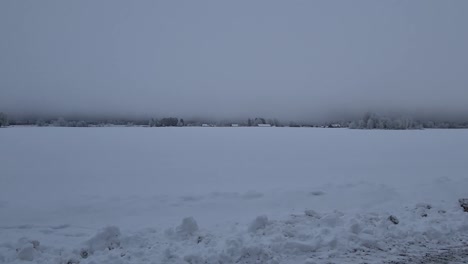 huge layer of mist on snowy field clouds and ground are pressed together