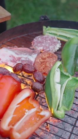 assorted meats and vegetables grilling on a barbecue
