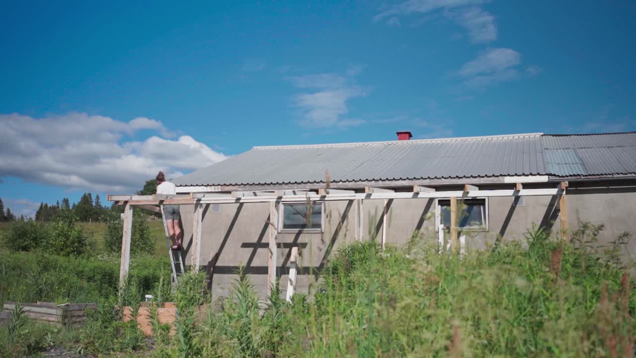 человек собирает деревянную крышу.