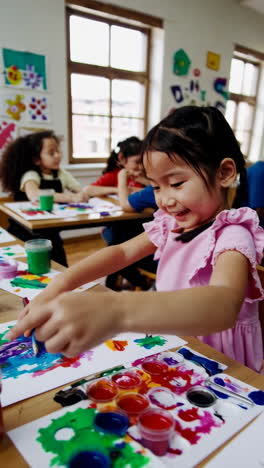 happy children painting in an art class