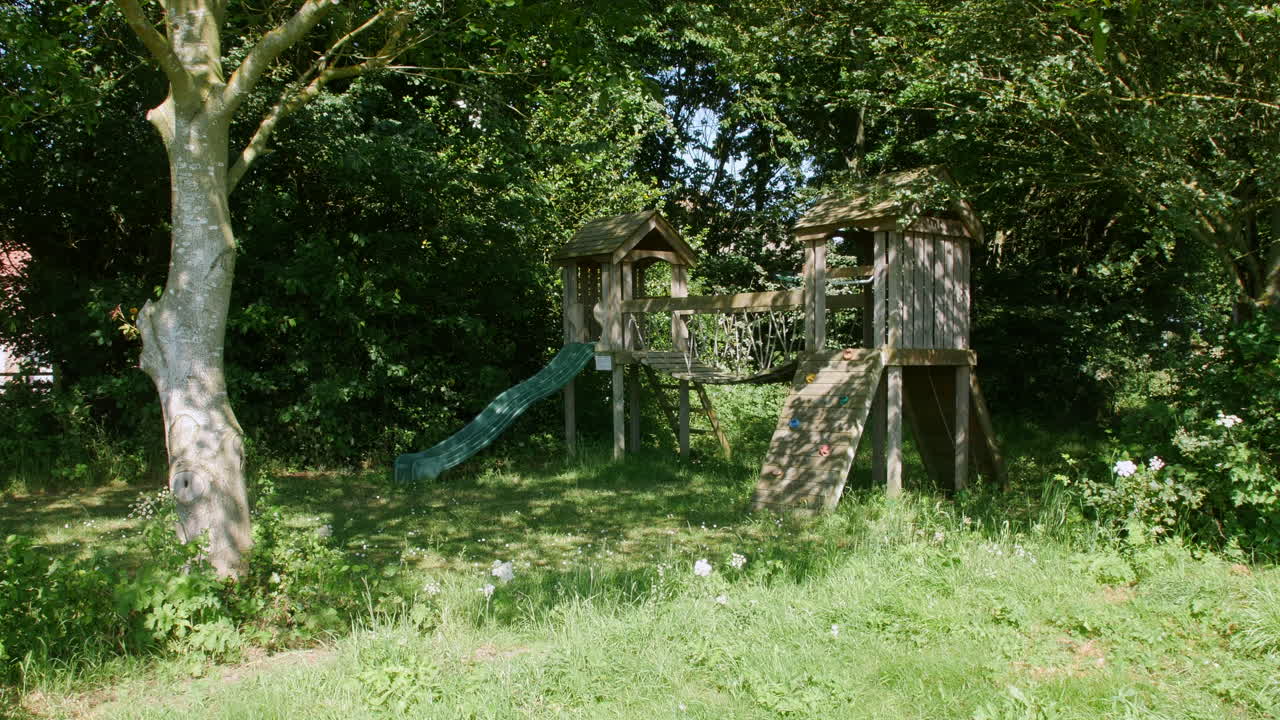 Wooden empty children's playground in the woods in summer
