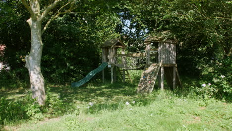 Wooden-empty-children's-playground-in-the-woods-in-summer