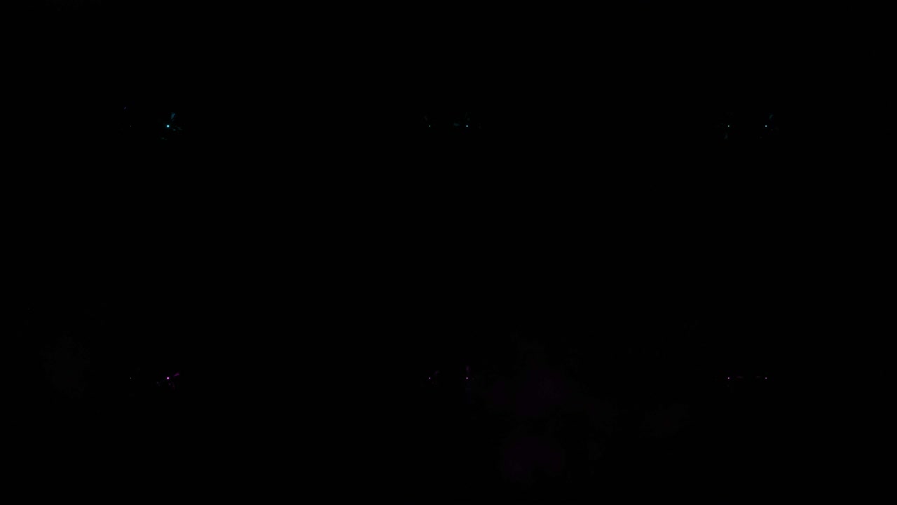 Colorful flashing of multicolored spotlights of light bulbs on the texture of squares. Seamless loop 4k animation