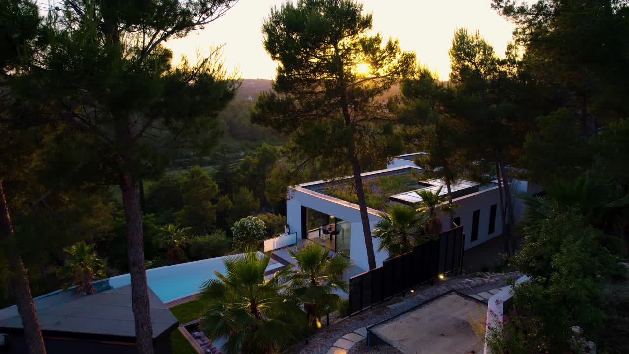 Slow aerial establishing shot of a luxury villa in St Cl&eacute;ment de la Riviere