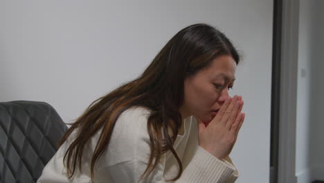 unhappy woman suffering with depression and anxiety sitting in reception of doctor or mental health worker 4