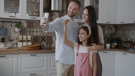 happy family taking a selfie in their new kitchen
