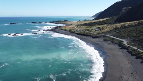 flying along the shoreline of a beach in cape palliser, new zealand