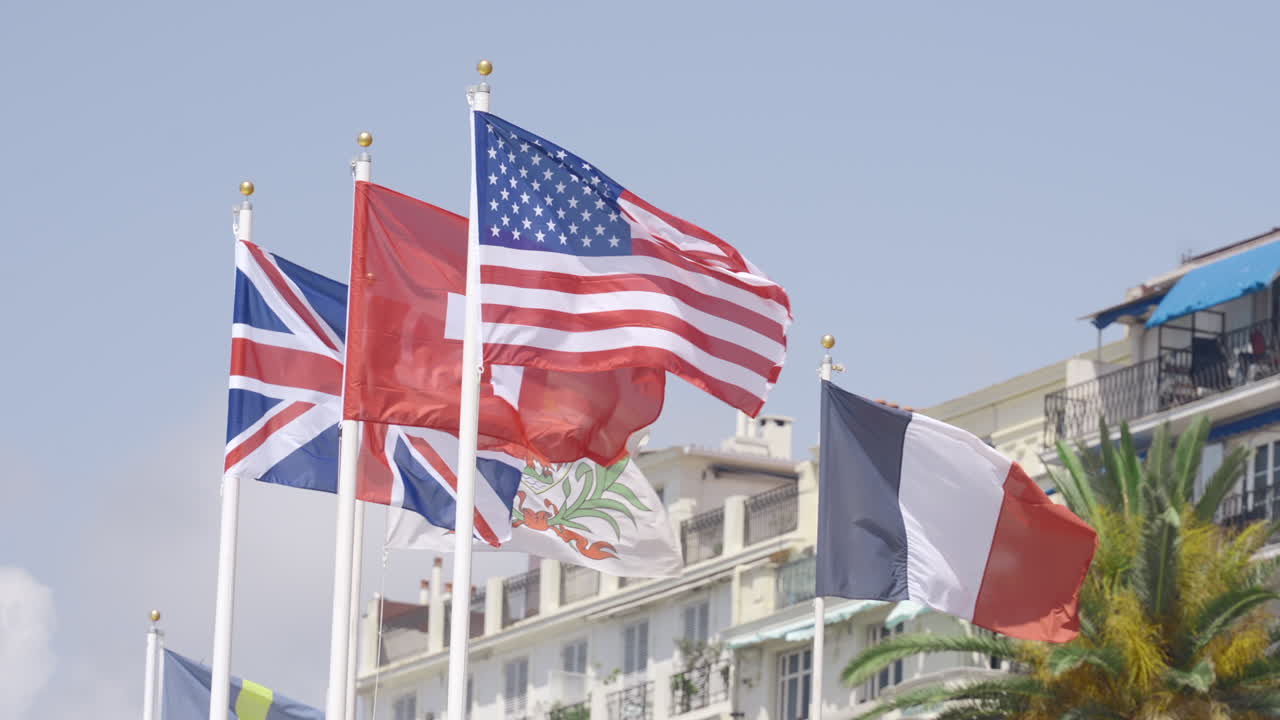 Flags of Several Nations Flying in a Coastal Town
