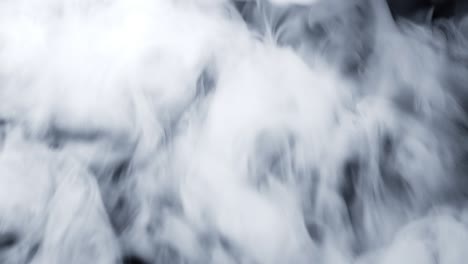 dry ice clouds overlay background. white abstract smoke slowly floating through black surface. atmospheric fog haze effect. real mystery steam. halloween concept footage.