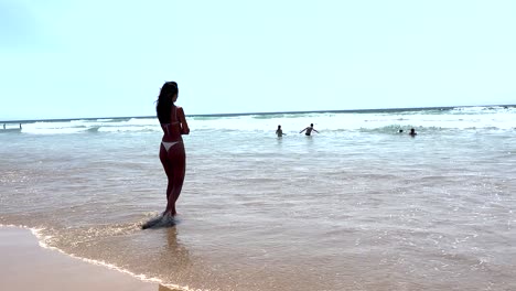 fit woman, thoughtful i decided to go into the sea to take a bath on cold and calm ocean