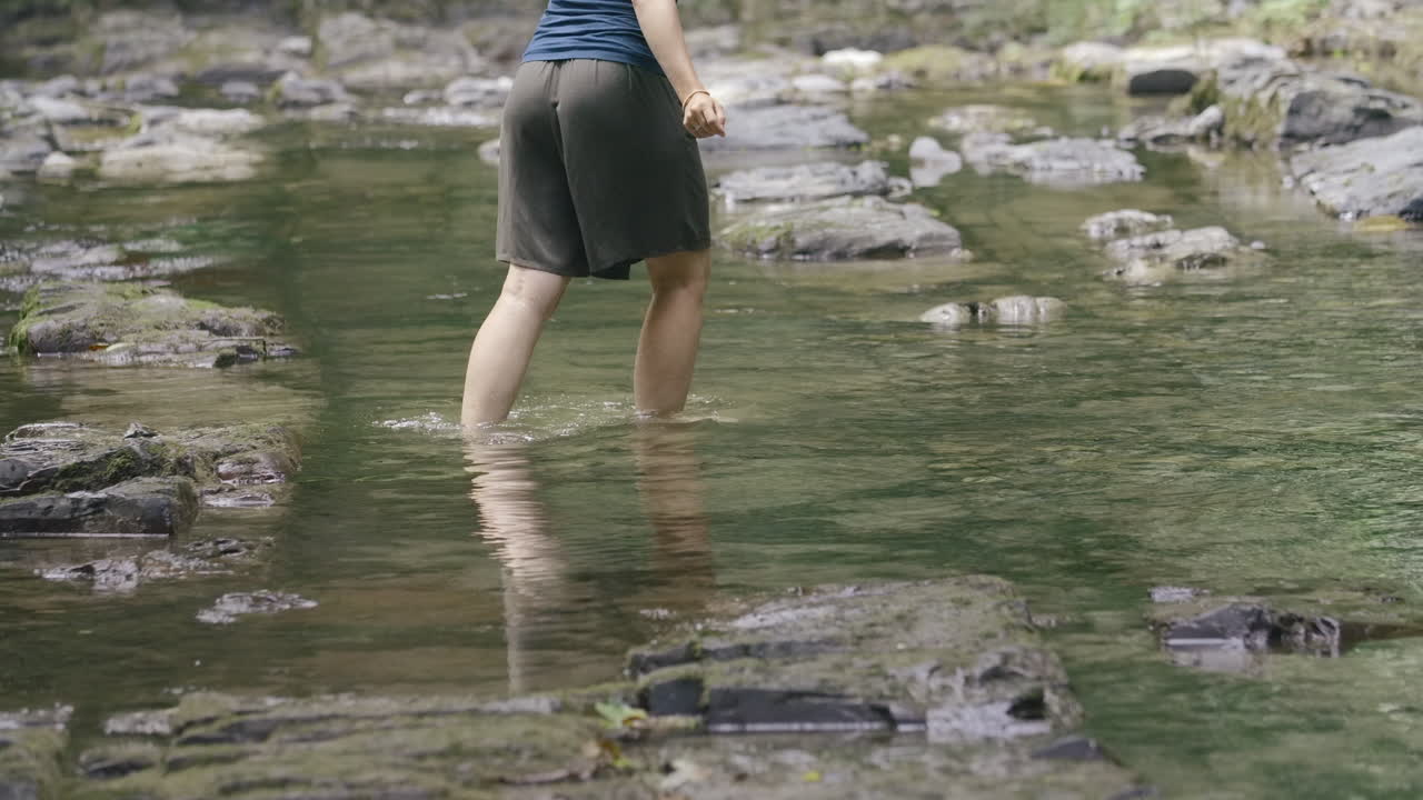 Woman walking through a shallow river
