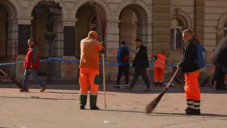 street sweeper cleaning town hall building and square after protest over fatal rail