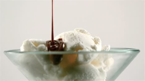 chocolate sauce pouring on ice cream