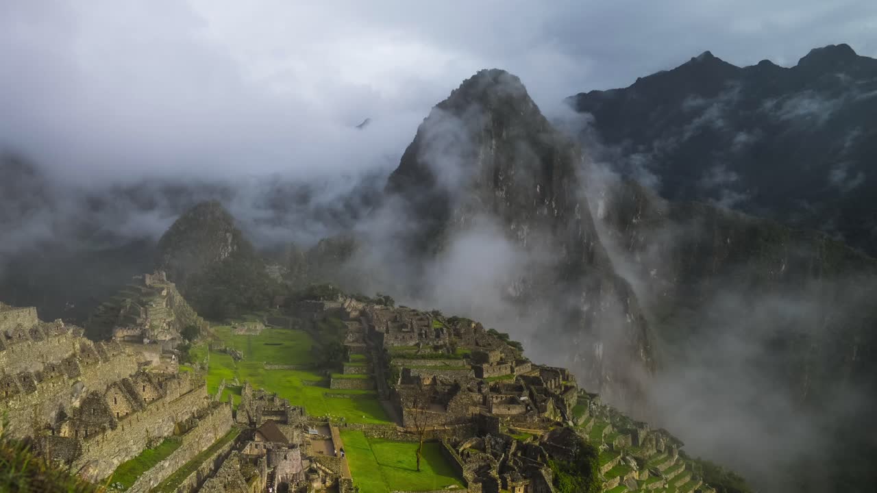 Machu Pichhu morning sunny sunrise low foggy fog cloud movement Peru Perú Time lapse jungle Hauny Picchu Mountain Classic Circuit 2 ancient Inca temple ruins citadel structure tourists guided tour
