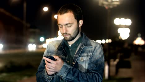 man send text message by cell with confused expression on face