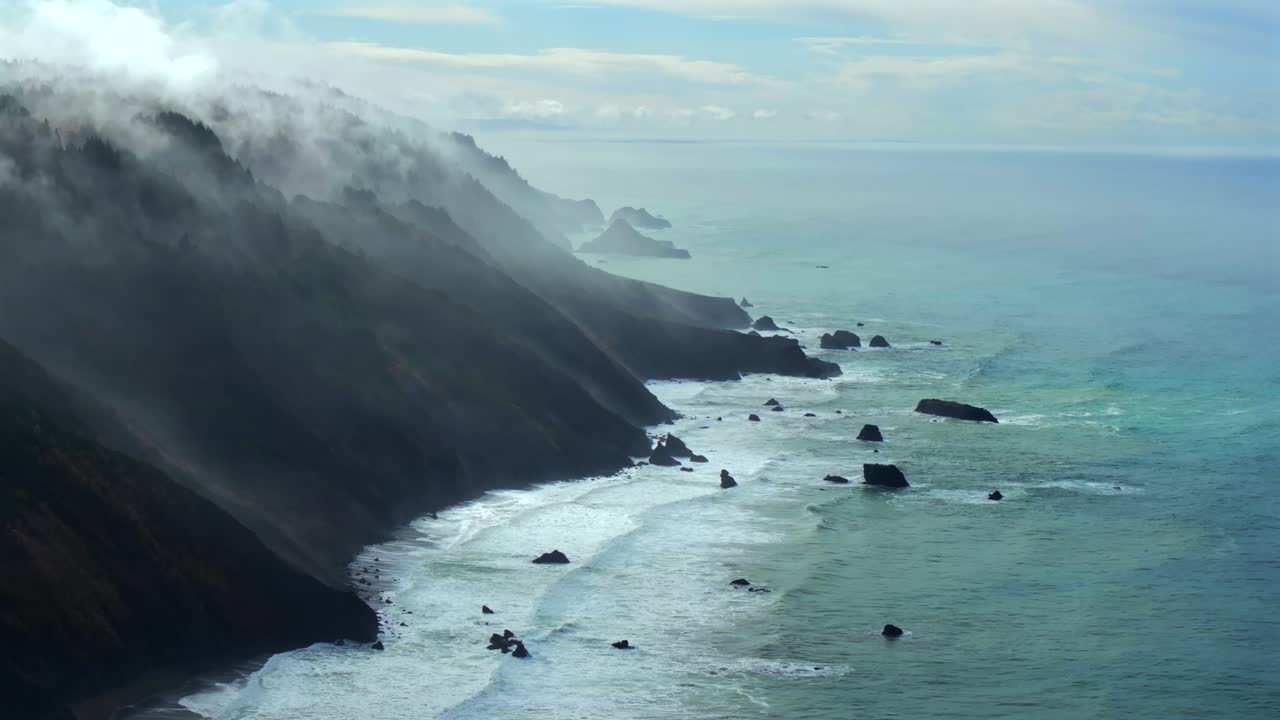 Rugged coastline Lost Coast Trail surf waves USAL Beach campground 4wd aerial drone California cloud layer blue sky mist rain fog PNW waves morning Chimney Rocks nature landscape circle right motion