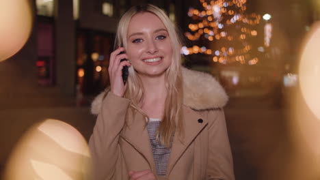 young woman gets a special christmas phone call from a close friend - in slowmotion