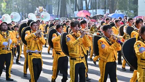 band of artists playing traditional music at the day of the dead parade in mexico city.