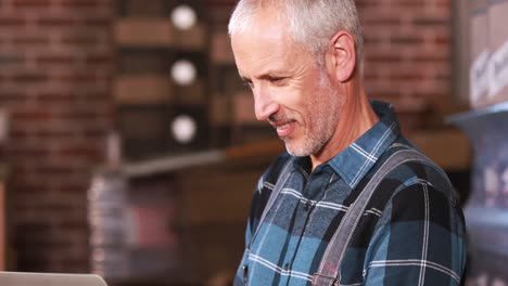 brewery worker using laptop to make inventory