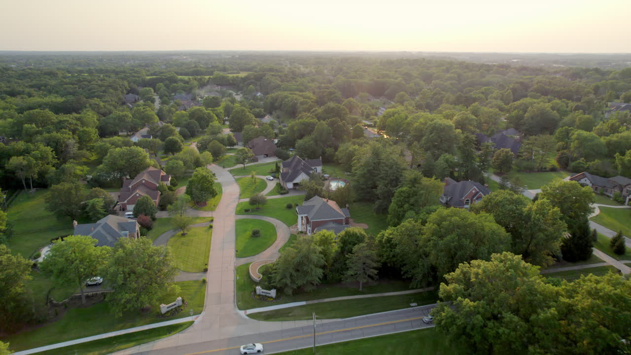 Flyover beautiful neighborhood at sunset in Town and Country in St