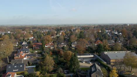 Jib-up-of-suburban-neighborhood-with-children-playing-on-a-school-square