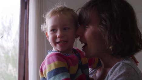 Caucasian-woman-laughing-with-baby-at-home