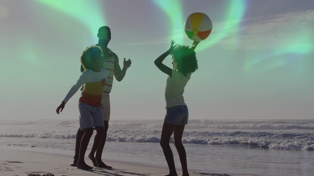 Ball tossed family leisure playing boy reaching girl catching holding aurora tinting silhouettes
