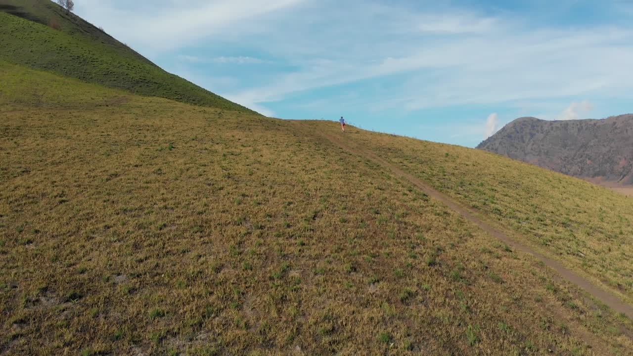 Uomo che corre sul vulcano Bromo, Giava Orientale, Indonesia