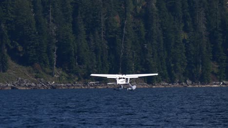 Seaplane-Landing-Over-Blue-Water-Lake-In-British-Columbia,-Canada