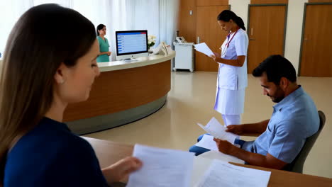 hospital reception area with patients and staff