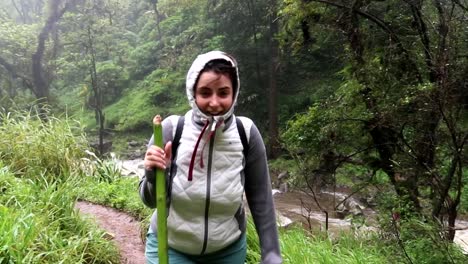 women hiking and getting wet from the nearby materuni waterfall, tanzania