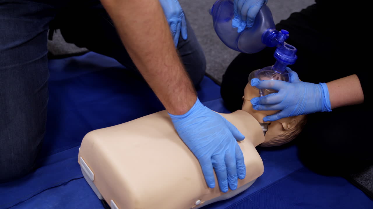 Chest compression on a dummy. Cardiopulmonary resuscitation. Training session on a chest compression and breathing by practitioners. Close-up.