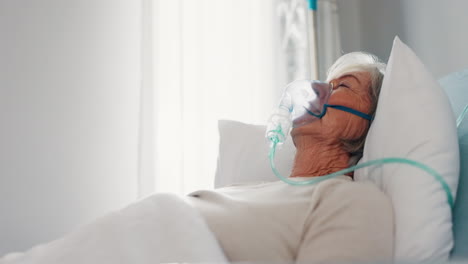 Hospital,-oxygen-mask-and-senior-woman-in-bed