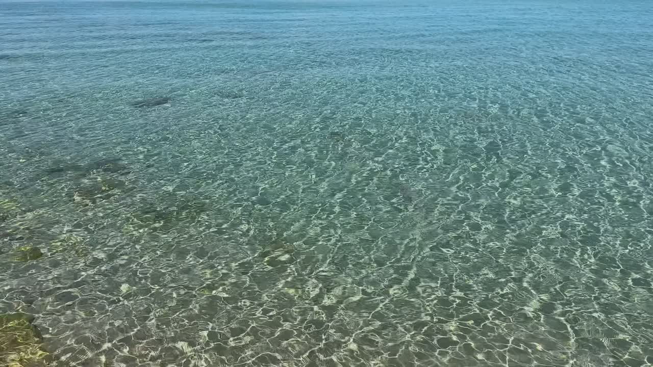 Stunning beach scene in Halkidiki, Greece, with elegant sunbeds facing the crystal-clear turquoise sea. A perfect summer escape in the heart of the Aegean.