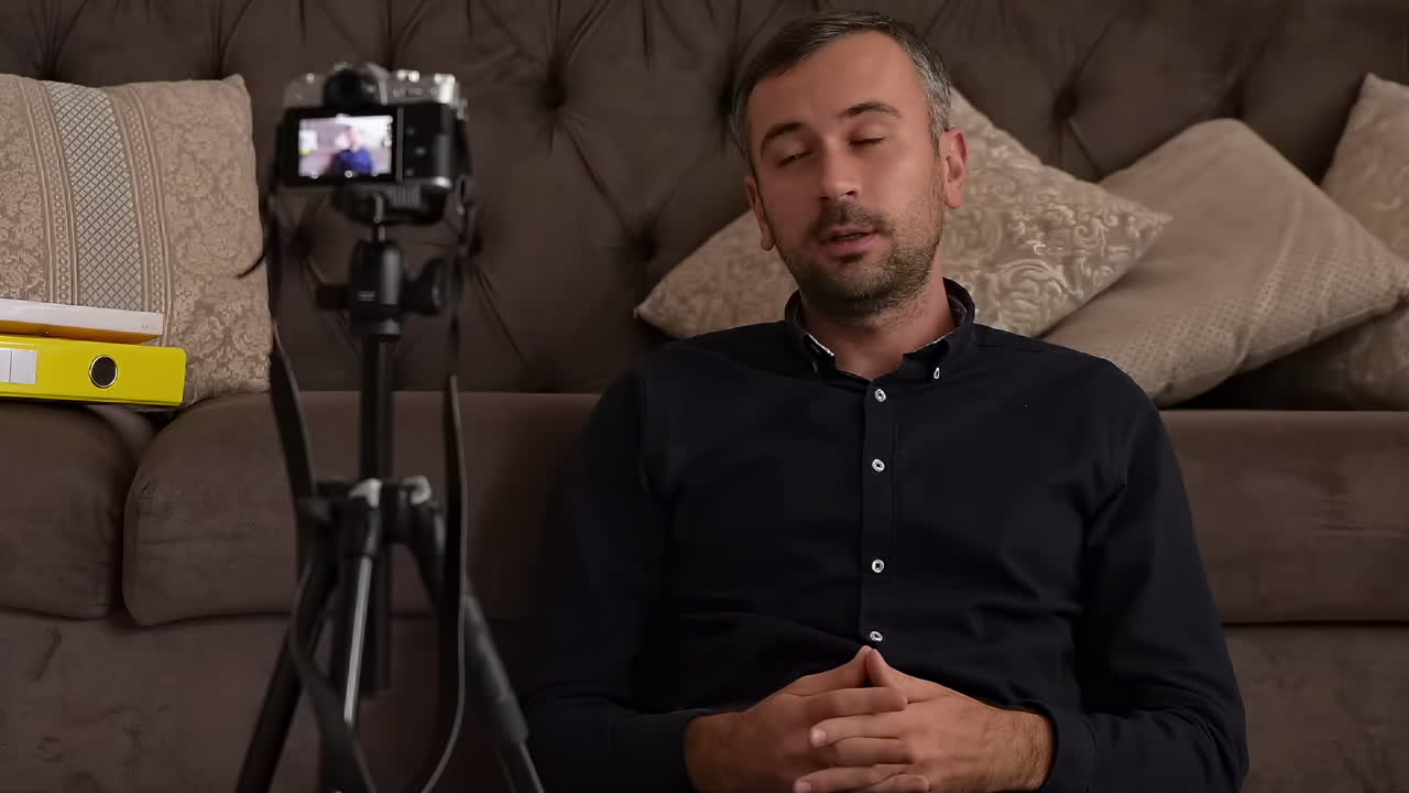 Man recording video blog on camera