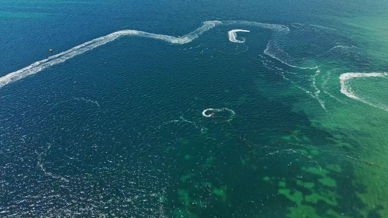 Jet ski racing in clear waters during a sunny day on the coast