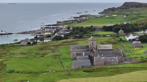 Drone-Shot-of-Iona-Abbey-and-Nunnery,-Island's-Landmark-and-Waterfront-Buildings-Scotland-UK