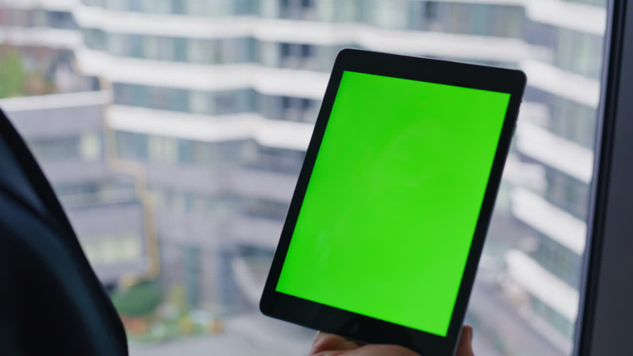 Businessman with Tablet by Window