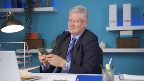 Dancing-happy-businessman-using-phone.