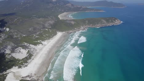 turquoise ocean and white sandy shore of squeaky beach in victoria, australia - aerial drone shot