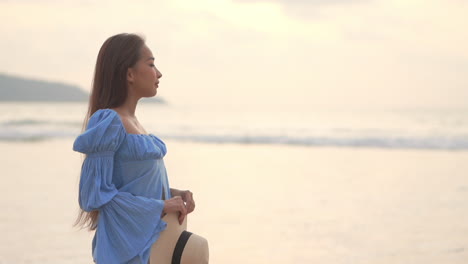 estrecha profundidad de campo de una mujer joven y bonita caminando junto con una marea oceánica entrante