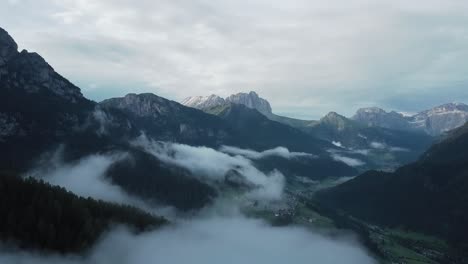 Drone-view-of-misty-Valle-di-Fassa-at-sunrise-in-Dolomites-Italy