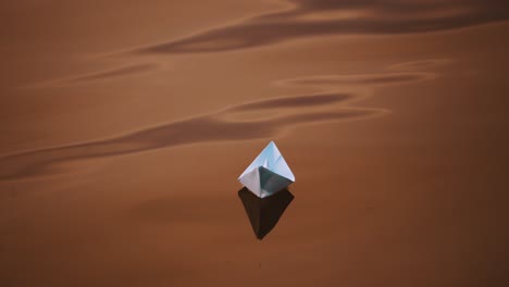 dark background of water surface and paper ship floating in the evening. homemade paper boat swimming outdoors at sunset.