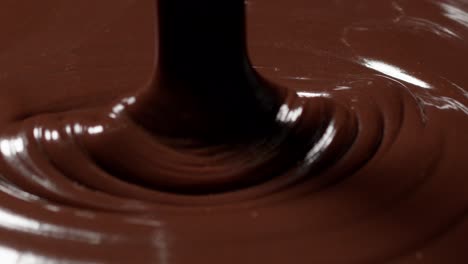 pouring melted liquid premium dark or milk chocolate with nuts, preparing confectionery dessert