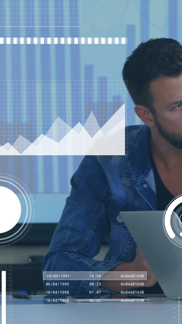Vertical video: Hand typing laptop starting AR overlays while man reviewing bar chart for business