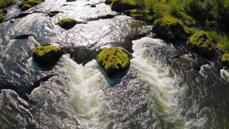river with moss-covered rocks