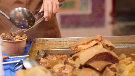 vendor prepares and serves traditional hong kong dish