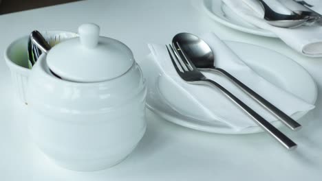 cutlery and empty plate on wooden background top down