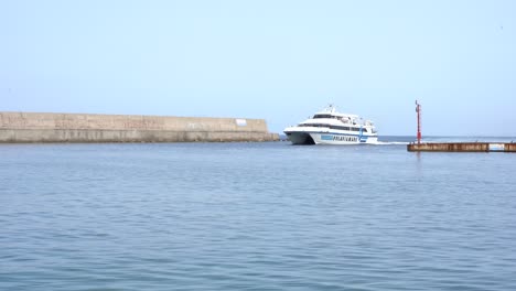 a boat entering the harbor of ischia forio, naples, italy