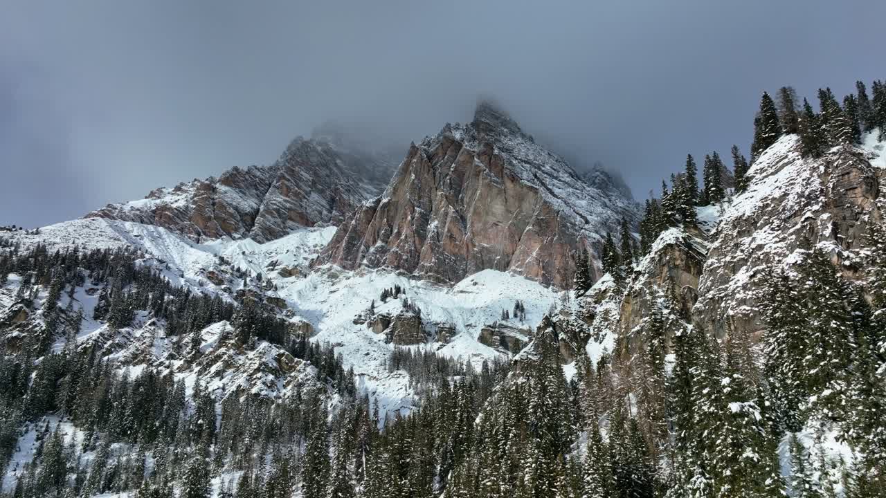 vista aérea de drones moviéndose a las montañas desde el valle con nieve en invierno